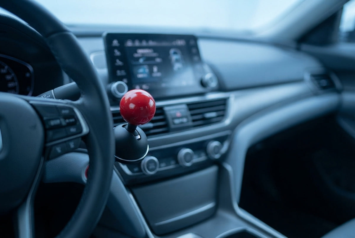 Close-up of a multicolored engine start-stop button cover installed in a modern car dashboard with soft blue lighting.